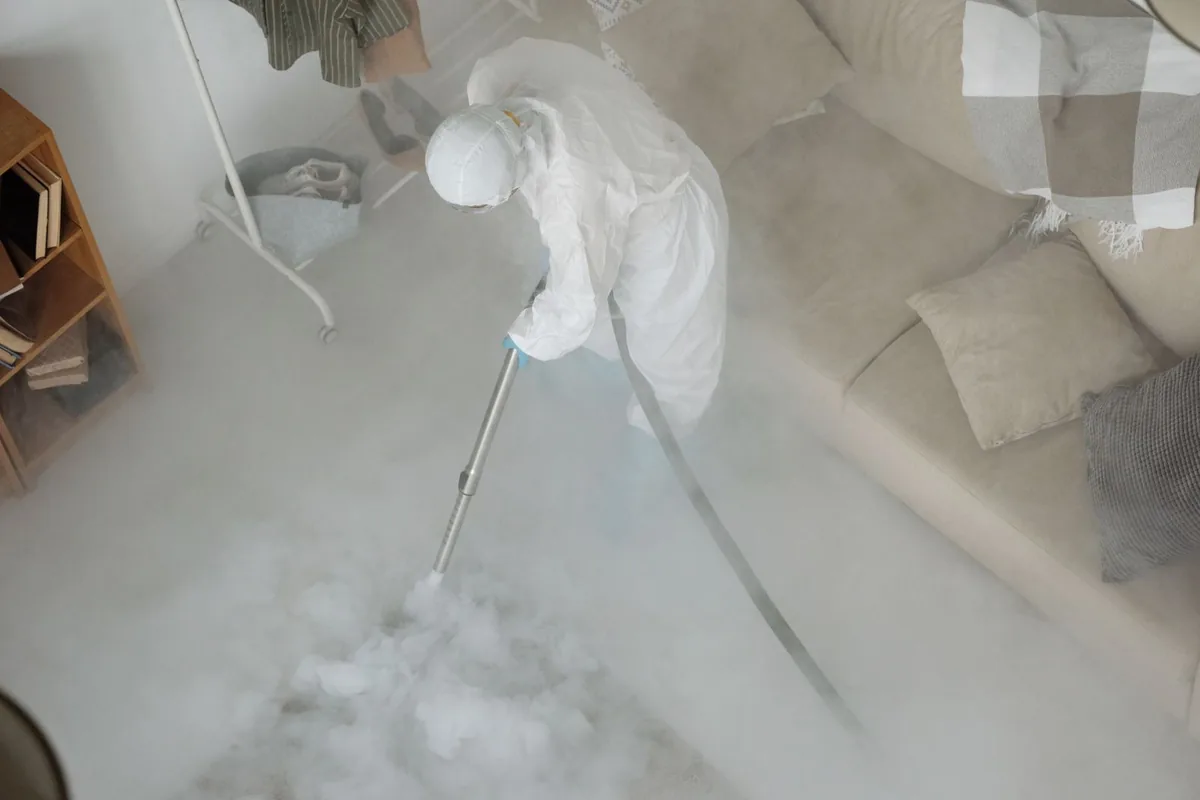 Biohazard cleanup technician in protective equipment, Atkins, AR